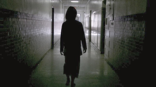 Joanna walking down the hall still image from film Behold
