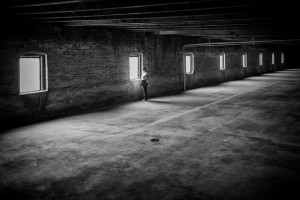 woman in empty warehouse poetic voices