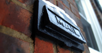 Top 10 Poems by Invitation - mail slot on brick wall