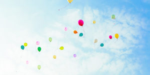 balloons fly away in sky