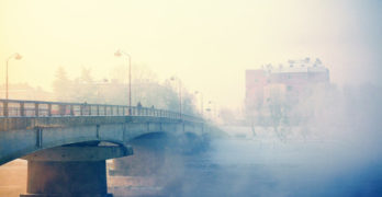 Bridge in city in fog