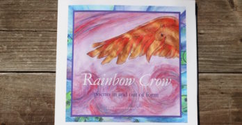 rainbow crow children's poetry on wood table