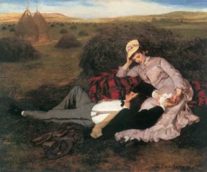 two lovers sit in a field with the man resting his head in the woman lap and she gazes at him