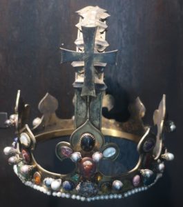 silver crown with many precious stones and pearls