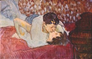 two lovers kiss on a bed