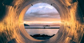 body of water seen through pipe by the sea