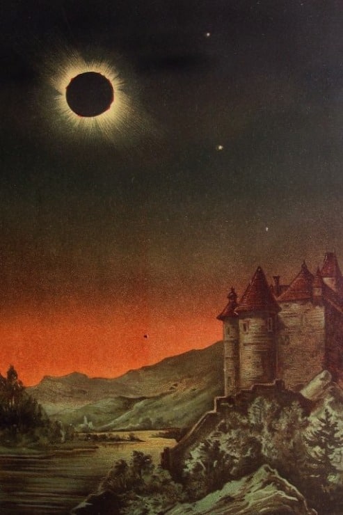 solar eclipse makes the background dark while a castle sits in the foreground