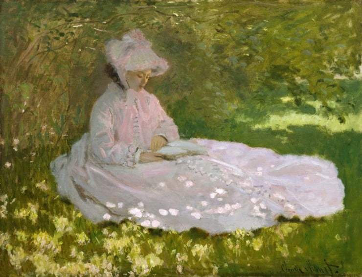 woman dressed in white sits in the garden shade 