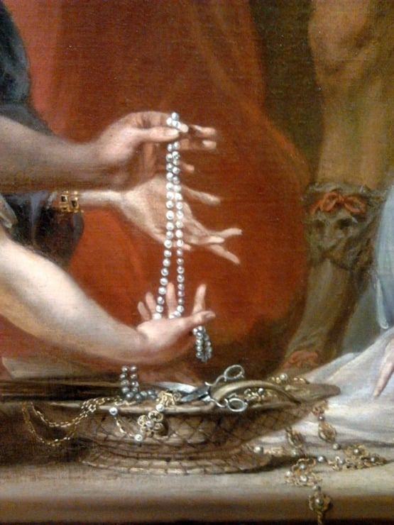 woman holding pearls in her hand