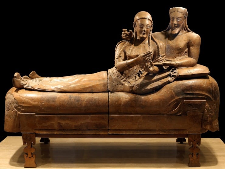 a terracotta sarcophagus depicting a married couple lounging. 