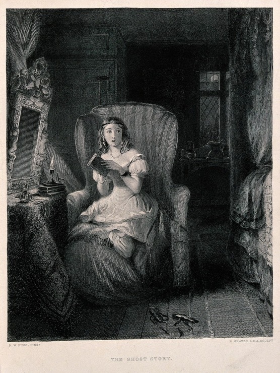 woman reads a ghost story in her room with her slippers off. she must have heard something frightening because her mouth and eyes are open
