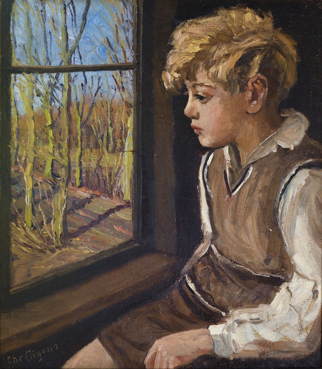 boy looks outside a window