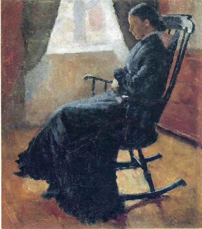 woman in a rocking chair by a window 