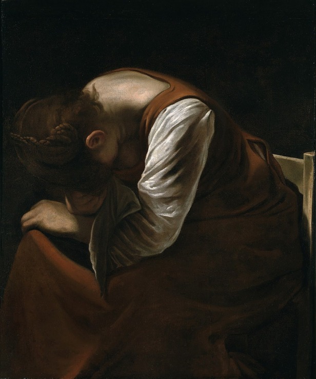 a woman bows her head in grief 